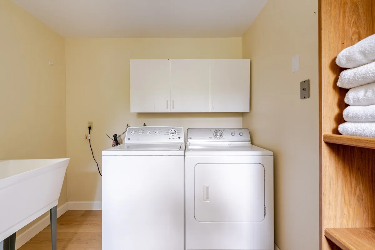 Laundry room with washer, dryer, and fresh towels