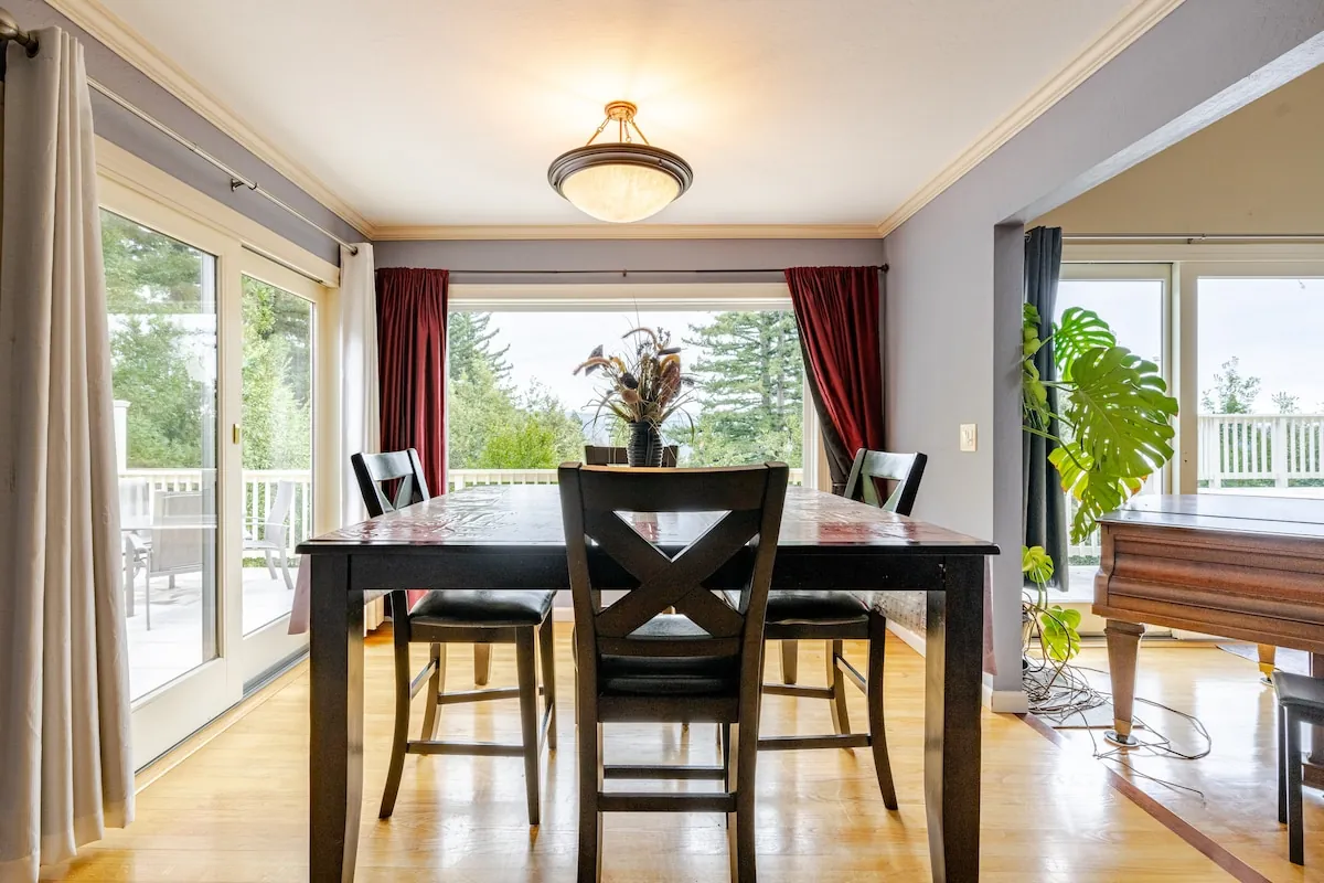 Formal dining room with forest-view windows